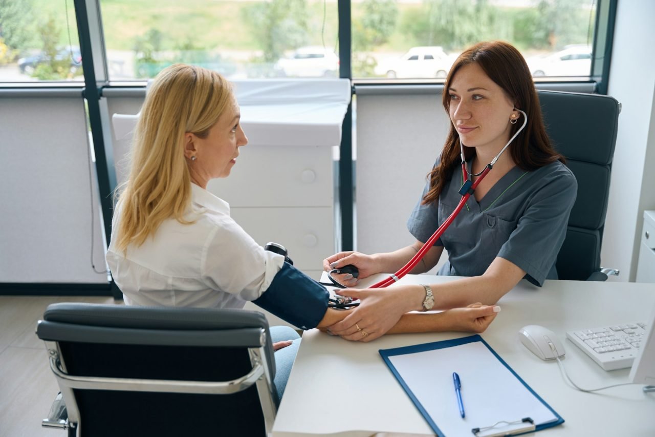adult-woman-undergoing-routine-health-check-with-family-doctor.jpg