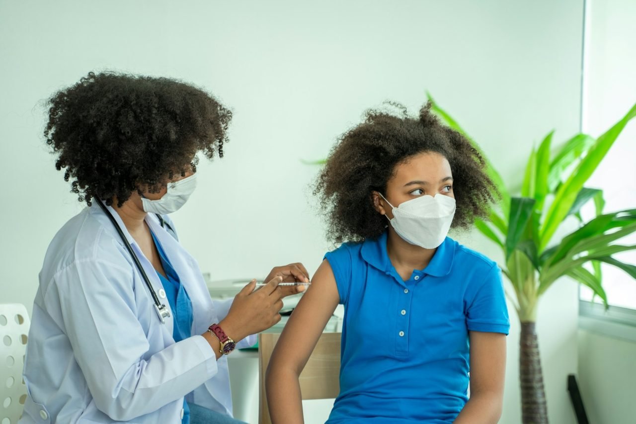 doctor-giving-injection-to-little-girl-in-hospital-immunization-concept-.jpg