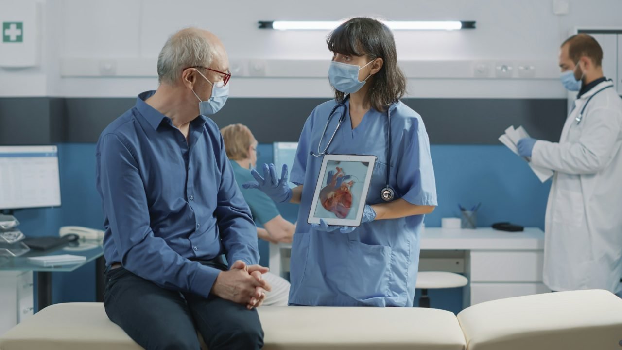 nurse-and-elder-patient-looking-at-cardiology-illustration.jpg